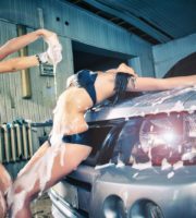 Models at the car wash in garage. Cross processing